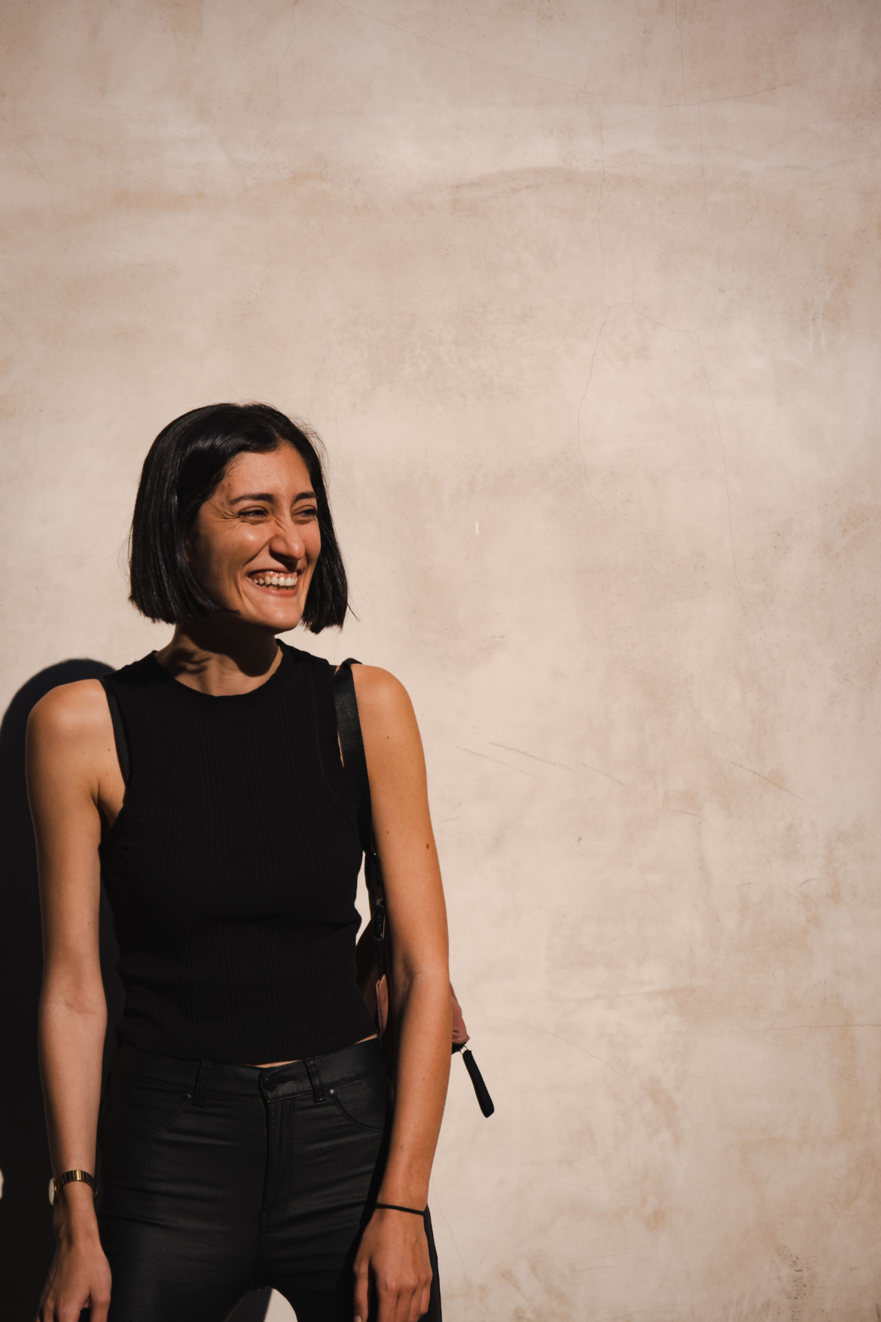 A woman laughing in warm sunlight