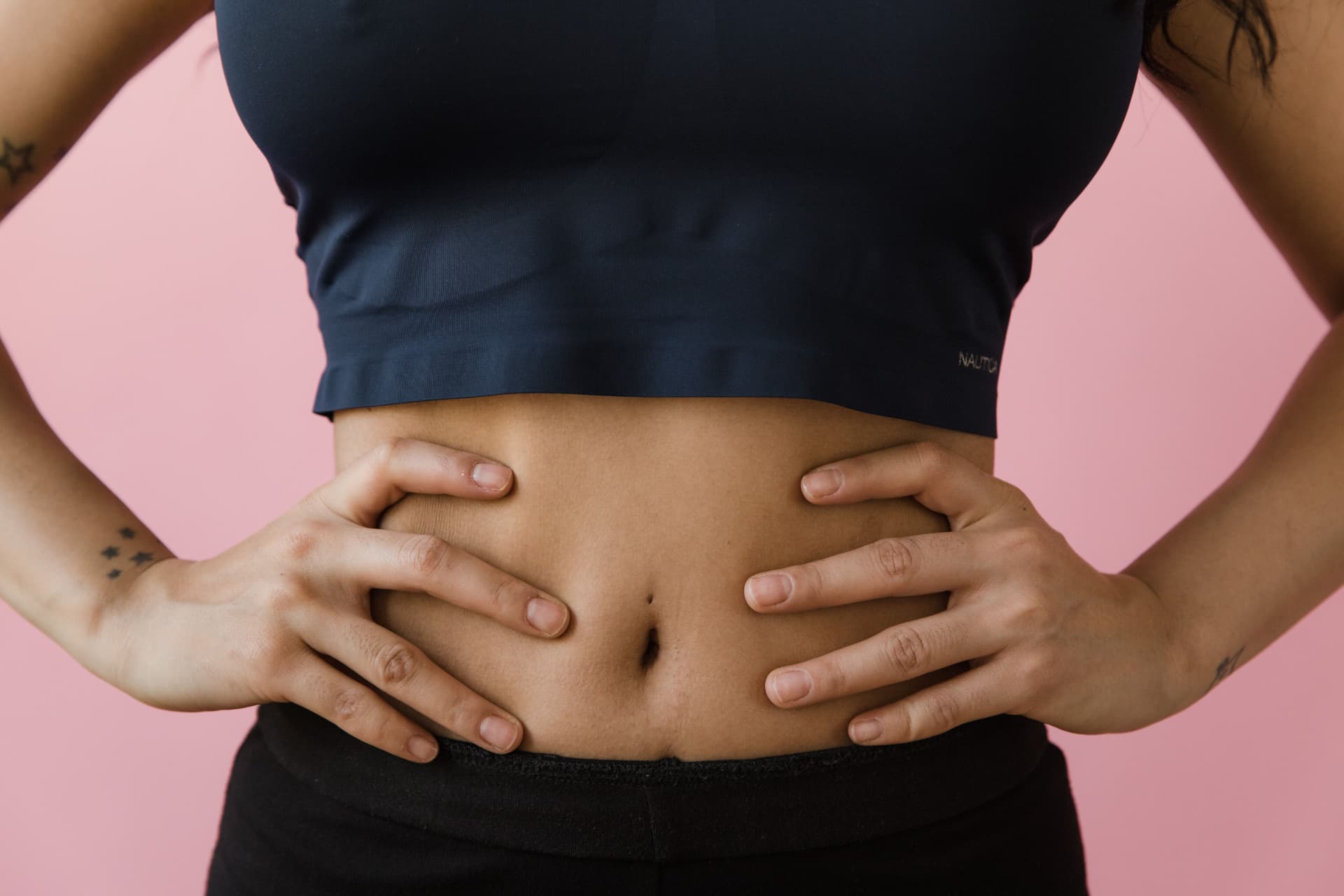 A woman with her hands on her abdomen